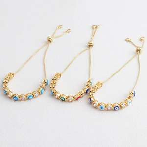 Macro detail of adjustable evil eye bracelets with colorful enamel and zircon inlays