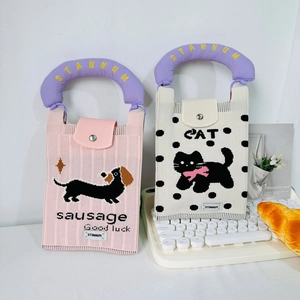 Detail of pink sausage dog and cream cat pattern knitted mini bags with snap buttons