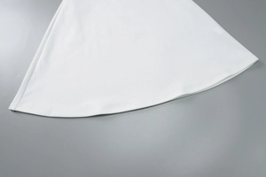 Detail of the white sleeveless bodycon dress showing the neat A-line hemline and soft fabric