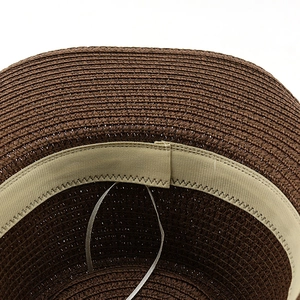 Detail of dark brown woven straw hat showing internal khaki sweatband and adjustable drawstring