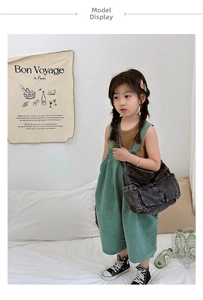 Close-up of children's vintage black denim crossbody bag with contrast stitching