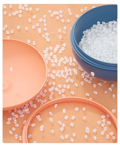 Detailed macro view of colorful round containers with scattered white moisture absorber beads
