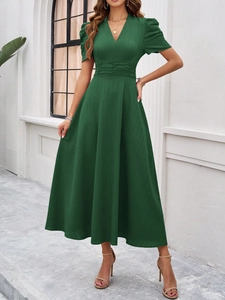 Detail view of the V-neck short sleeve dress in dark green with ribbed texture