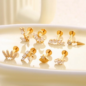 Eight-piece gold titanium labret stud set with flower, crown, and leaf shapes