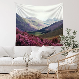 Detail of bohemian mountain tapestry with purple peaks and floral valley in a cozy room