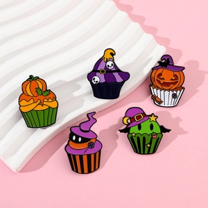 Detailed close-up of 5 Halloween cupcake enamel pins with pumpkin and skull designs