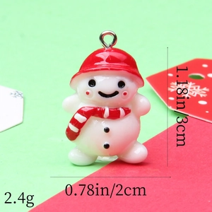 Macro view of snowman resin pendant showing 3cm height and 2cm width dimensions