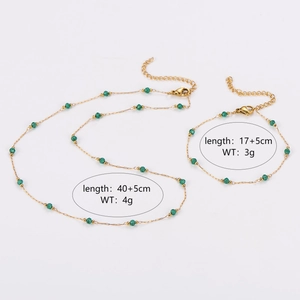 Golden chain necklace and bracelet jewelry set featuring emerald green beads