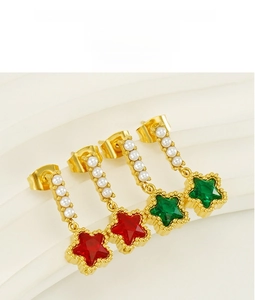 Detailed view of gold star earrings featuring vibrant zircon stones and white faux pearls