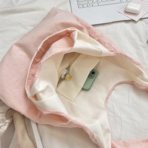 Detail der rosa gepunkteten Canvas-Tasche mit Reißverschluss-Innentasche und Innenfutter