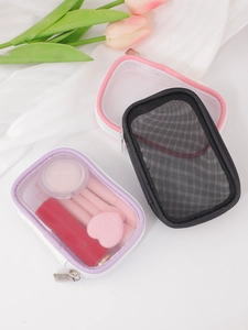 Detail view of mesh makeup pouches in purple, pink and black with smooth metal zippers