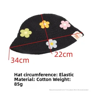 Macro detail of handmade knit flower bucket hat showing cotton texture and dimensions