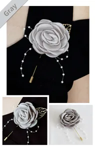 Détail de broche rose satin gris avec perles blanches et feuilles dorées sur épingle