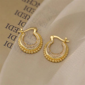 Macro shot of 18K gold plated U-shaped earrings with pave-set cubic zirconia stones