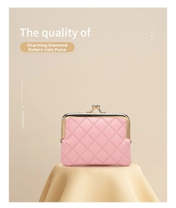 Detailed view of pink quilted faux leather coin purse with golden metal clasp closure