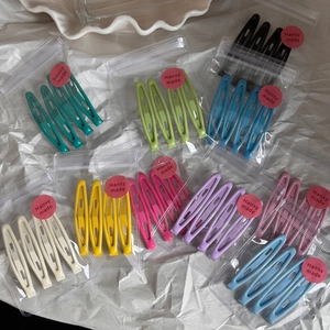 Detail of matte finish metal hair clips in various candy colors and pastel tones