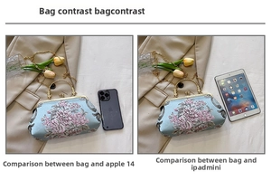 Size comparison of light blue floral embroidered satin evening bag with iPhone 14