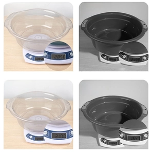 Detailed view of large transparent and grey washbasins on digital scales for weight comparison