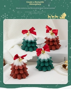 Close-up of Christmas tree scented candles with festive red bows and golden bells
