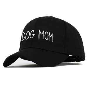 Close-up of white DOG MOM embroidery on a black cotton six-panel baseball cap