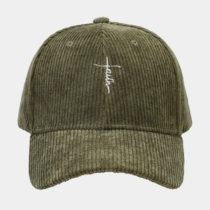 Close-up of olive green corduroy baseball cap with white faith embroidery and cross