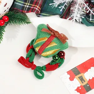 Detailed view of festive Christmas scrunchie with green gift plush and bell ornaments