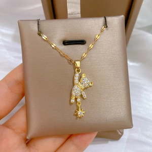 Luxurious gold star teddy bear necklace with full rhinestone pavé on a dainty chain