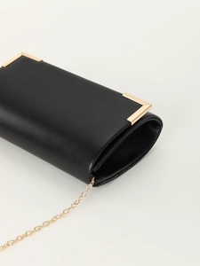 Detail of black matte PU leather clutch bag featuring elegant gold metal corners and chain