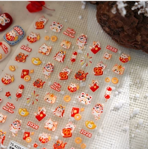 Macro shot of 5D embossed nail stickers with lucky cat and 2026 New Year patterns