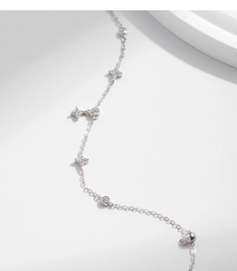 Macro shot of silver S925 lucky four-leaf clover bracelet with sparkling cubic zirconia