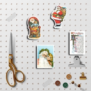 Retro Christmas Santa stickers and cards set displayed on a white pegboard for DIY crafts
