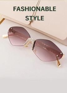 Close-up of diamond-cut rimless sunglasses featuring snake-patterned golden metal temples
