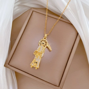 Detailed macro shot of a gold-toned grim reaper necklace pendant with shimmering crystals