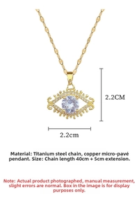 Detail view of gold evil eye necklace with 2.2cm pendant size and 40cm titanium chain