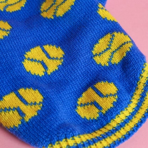 Macro shot of the blue and yellow knitted fabric texture on pet sweater apparel