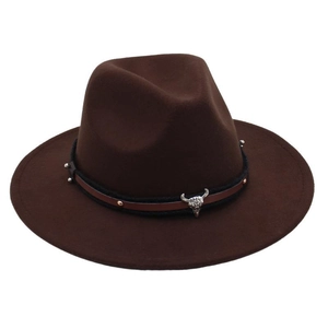 Detailed view of dark brown felt fedora featuring a vintage silver bull head skull emblem