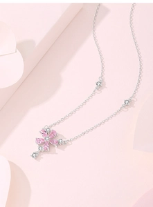 Macro detail of S925 silver peach blossom necklace with pink zircon tassels and crystals