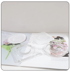 Close-up of clear acrylic display trays in round and square shapes on magazine
