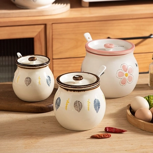 Japanese ceramic lard storage jars with floral patterns, lids and spoons in cozy kitchen