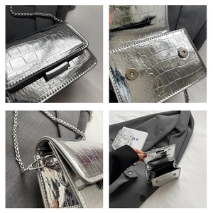 Detail view of silver crocodile pattern mini bag with metal chain and magnetic snaps