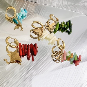 Golden ocean earrings with colorful coral beads and sea creature pendants on silk
