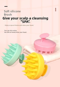 Detail view of colorful silicone scalp massager brushes on a soft background with a white towel