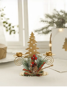 Macro detail of golden Christmas candle holder with pine needles, red berries and cones