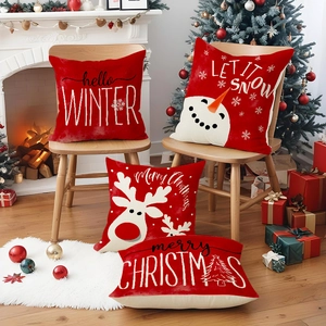 Set of four red linen Christmas pillow covers featuring snowmen and reindeer patterns
