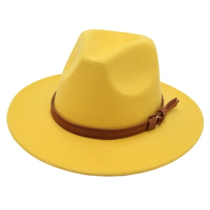 Detail of yellow wool fedora hat featuring a brown leather belt strap and gold buckle