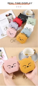 Detail of mini cat-shaped pouch charms in various colors with gold metal keychains