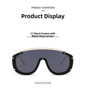 Close-up of C1 oversized shield sunglasses with black frame and gold metal accents