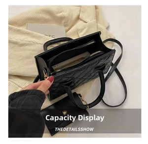 Top view of black quilted handbag interior showing zippered compartments and large capacity