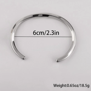 Detailed view of polished C-shaped twisted cuff bracelet with 6cm inner diameter size