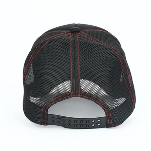 Close-up of black mesh trucker hat with red stitching and adjustable snapback closure